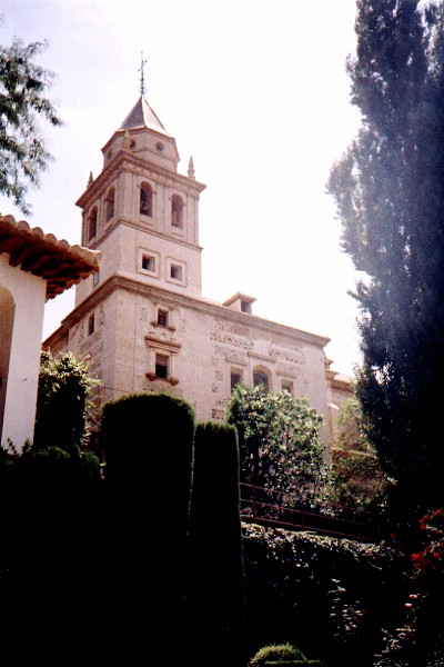 Looking up from the gardens at a bell tower inside the Alhambra