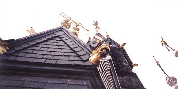 Various gold ornamental figures adorning the top of the belfry